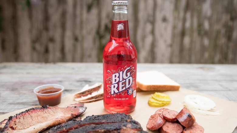 Big Red soda in a glass bottle next to Texas barbecue