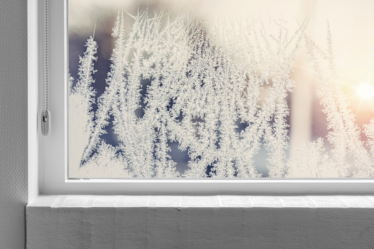 The interior of a frosty, snowy residential window.