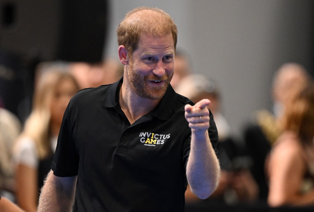 Prince Harry in a black polo shirt with