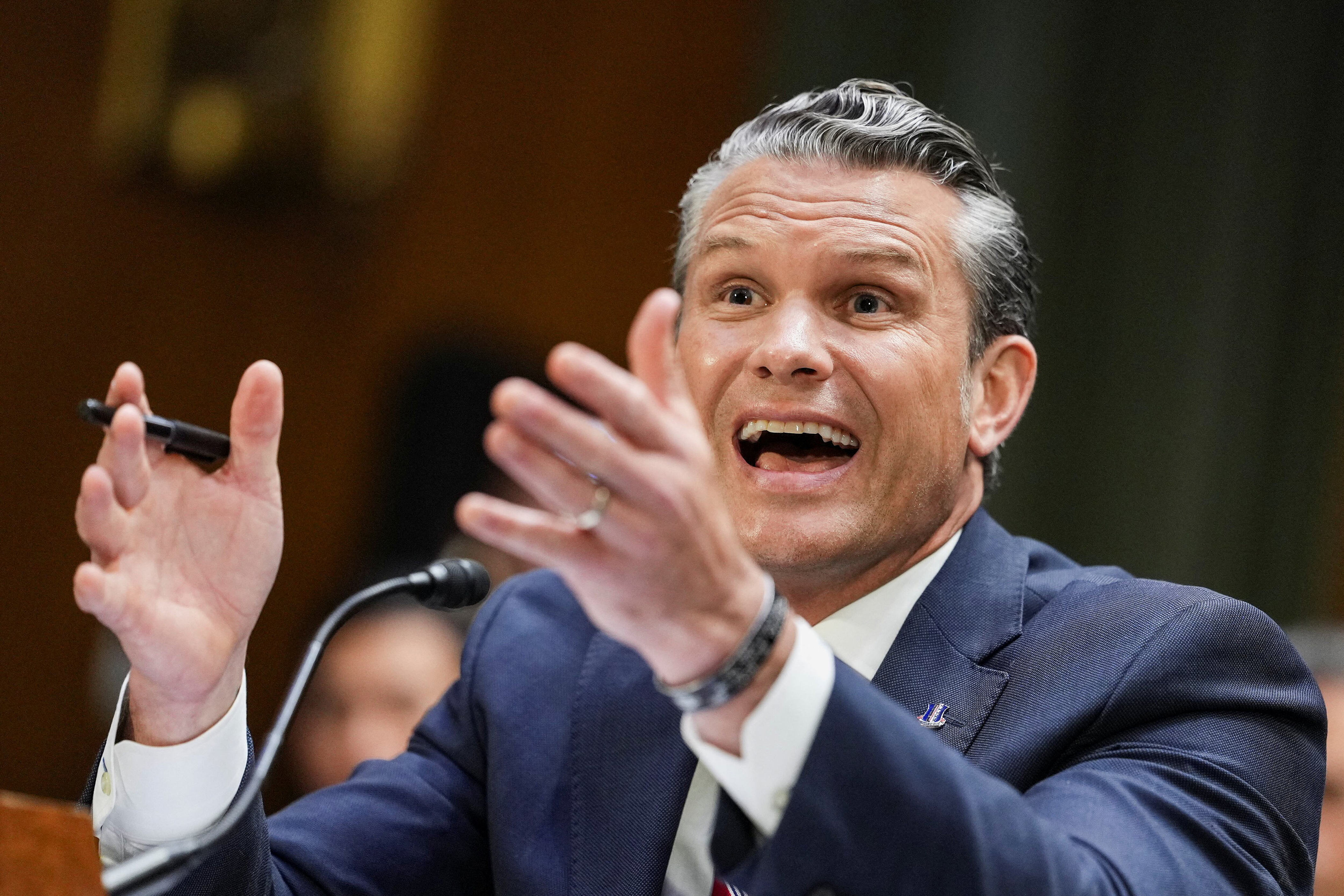Secretary of Defense Pete Hegseth gestures as he testifies. / Eric Lee/Reuters