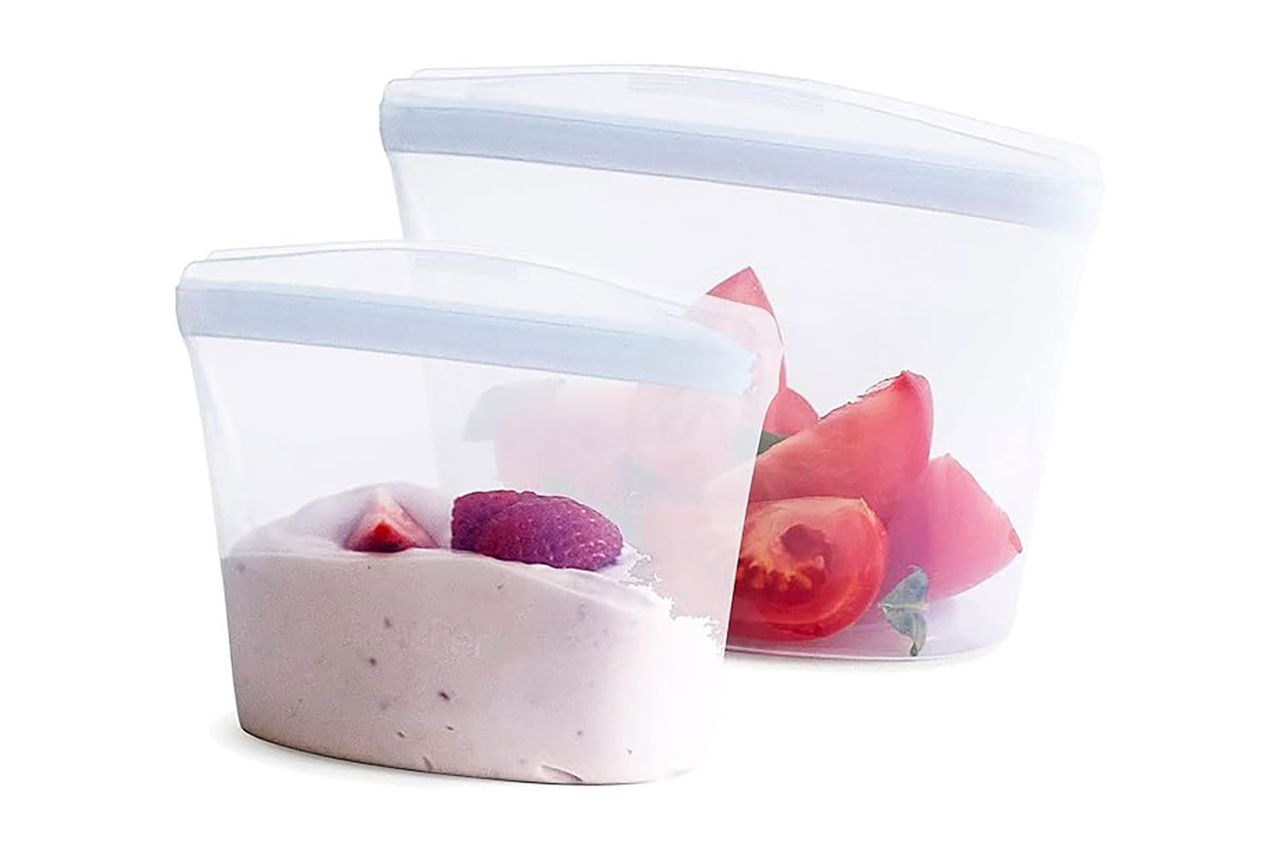 Two silicone reusable food storage bags containing food items