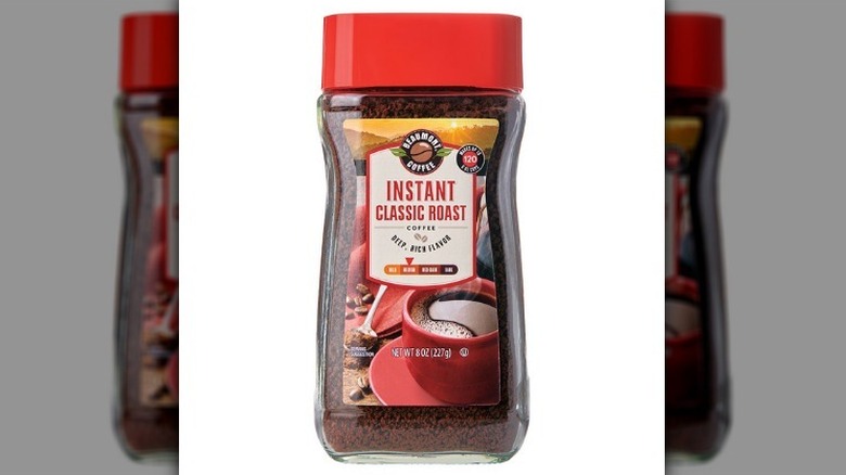 Instant coffee classic roast in a plastic bottle with a red lid on a white background.