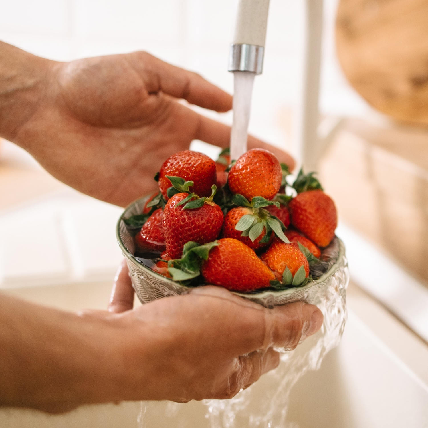 Products like vinegar and salad spinners are affordable and effective at cleaning strawberries.