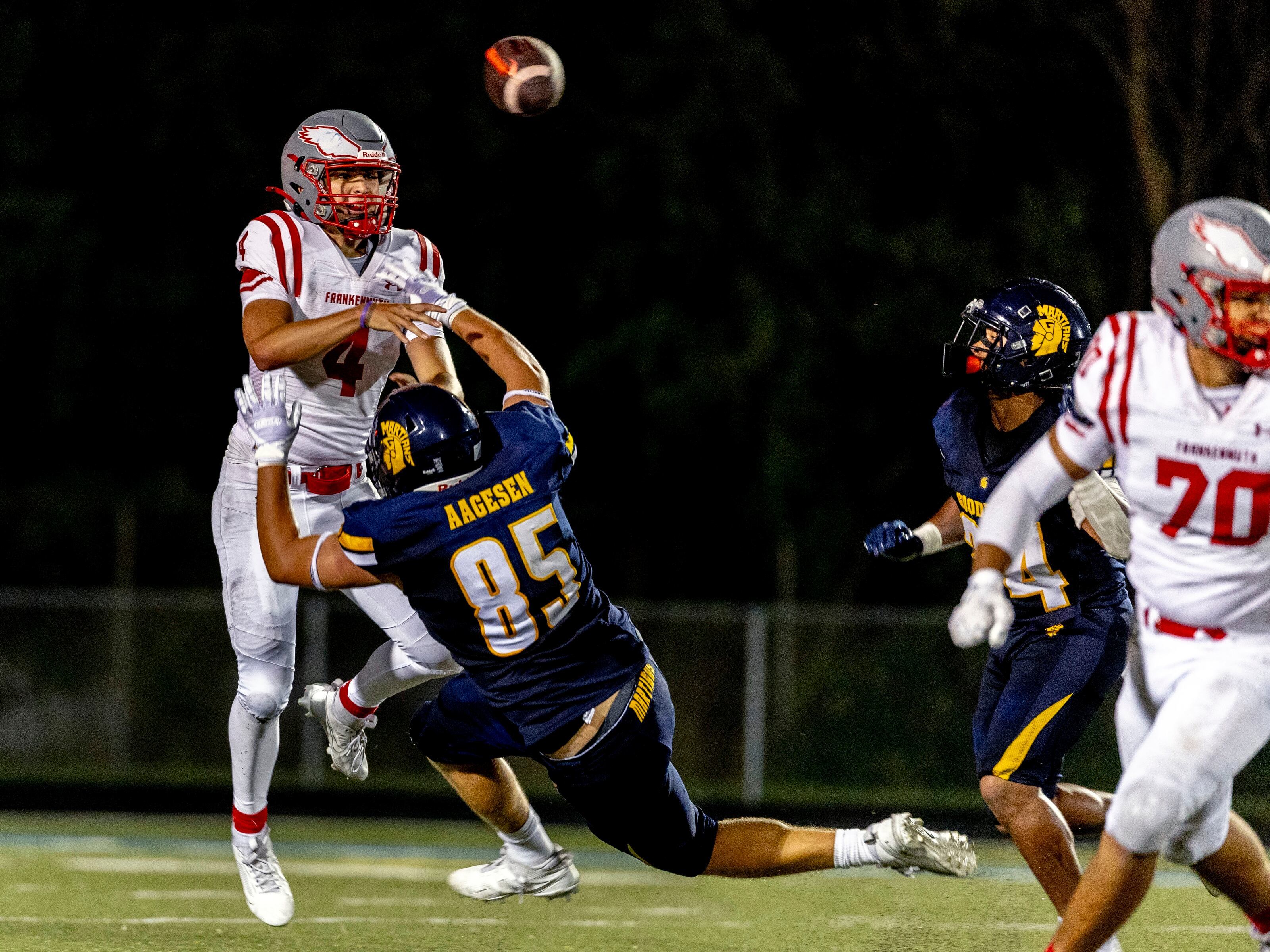 Goodrich junior offensive lineman Drew Aagesen (85) puts heavy pressure on Frankenmuth senior quarterback Lleyton Hoard (4), who is forced to throw an incomplete pass during the season-opening game on Thursday, Aug. 28, 2025 at Goodrich High School. Goodrich defeated Frankenmuth 17-14.