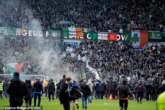 Rangers supporters run towards the away end after the Scottish Cup tie