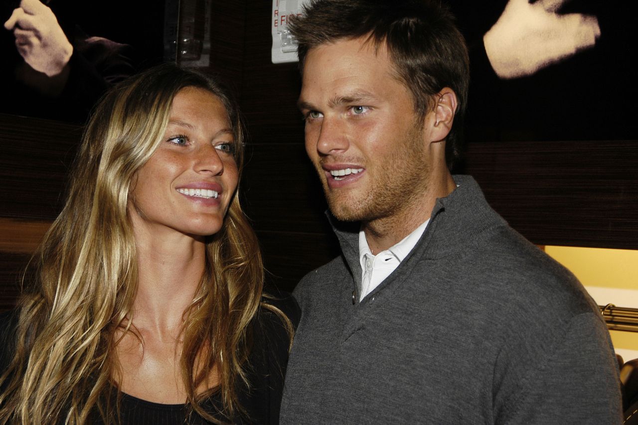 Tom Brady and Gisele Bndchen smiling together indoors