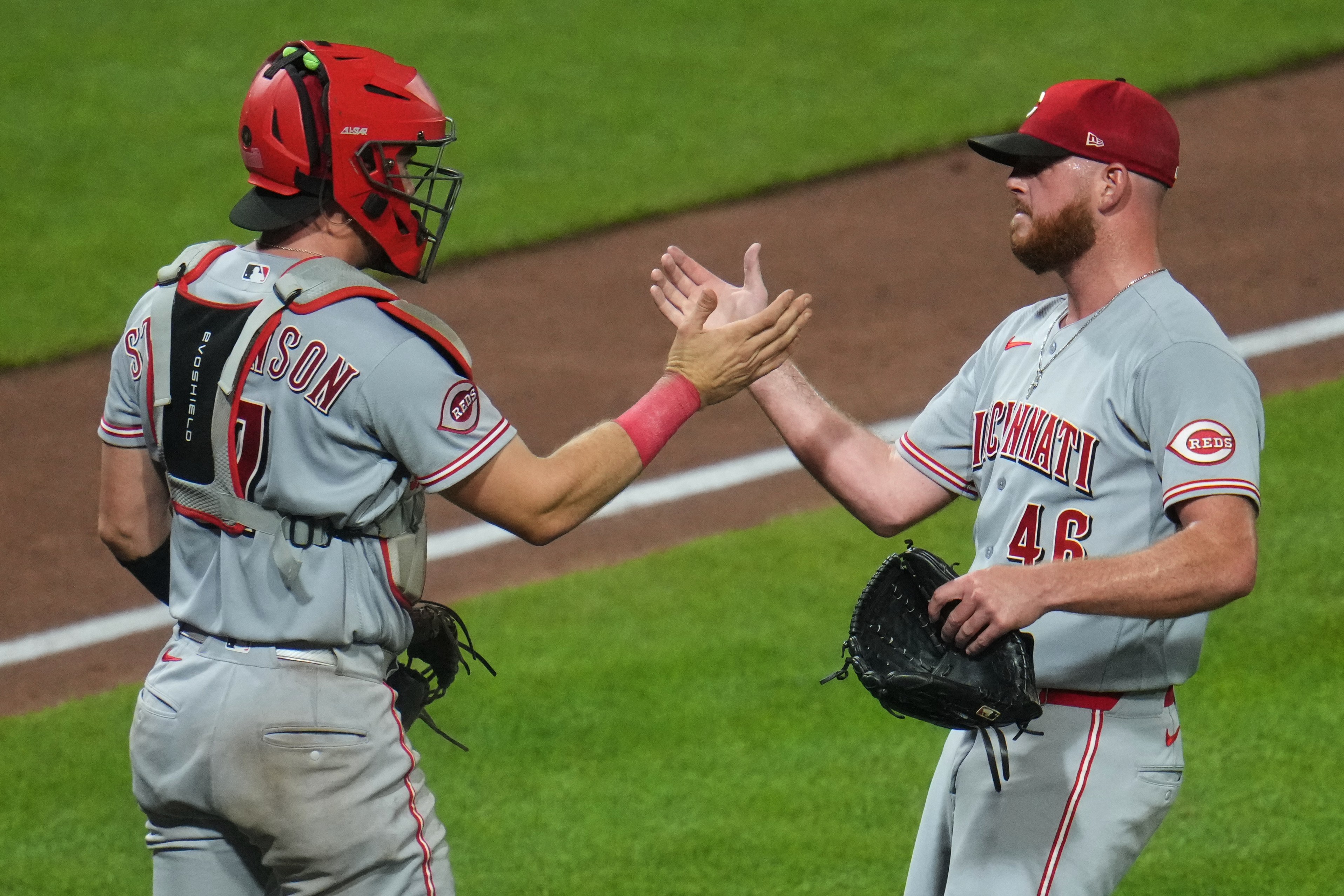 Cincinnati Reds pitcher Caleb Ferguson (46) celebrates with catcher Tyler Stephenson after getting the final out of a baseball game against the Pittsburgh Pirates in Pittsburgh, Friday, June 26, 2026. (AP Photo/Gene J. Puskar)