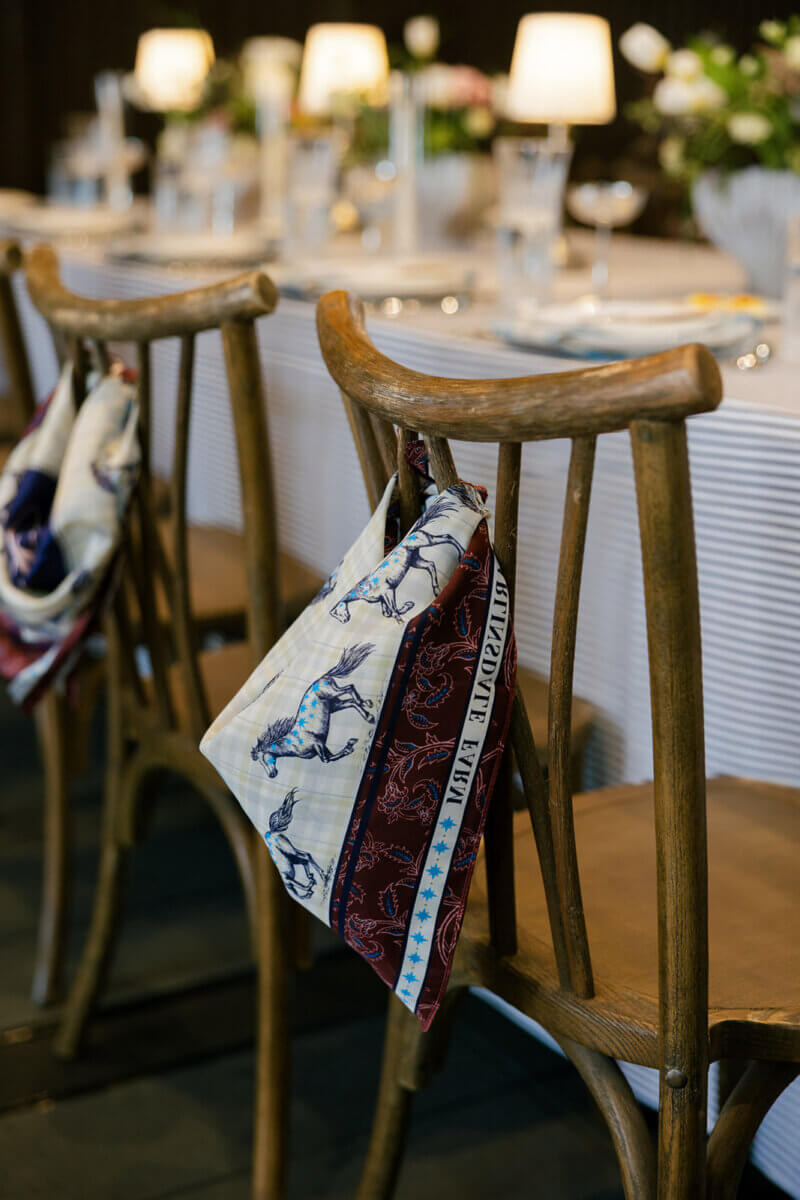 “I designed custom silk scarves featuring an equestrian design and details of Harlinsdale Farm as a favor for each guest,” Claire shares. “They were tied to each chair as guests walked into the reception and waved in excitement as we made our grand entrance.” Image: Rachel Fugate Photography