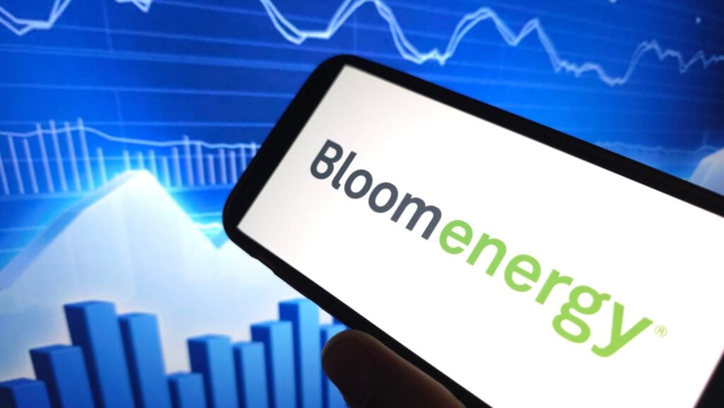 Bloom Energy logo displayed on a phone screen with a stock chart background