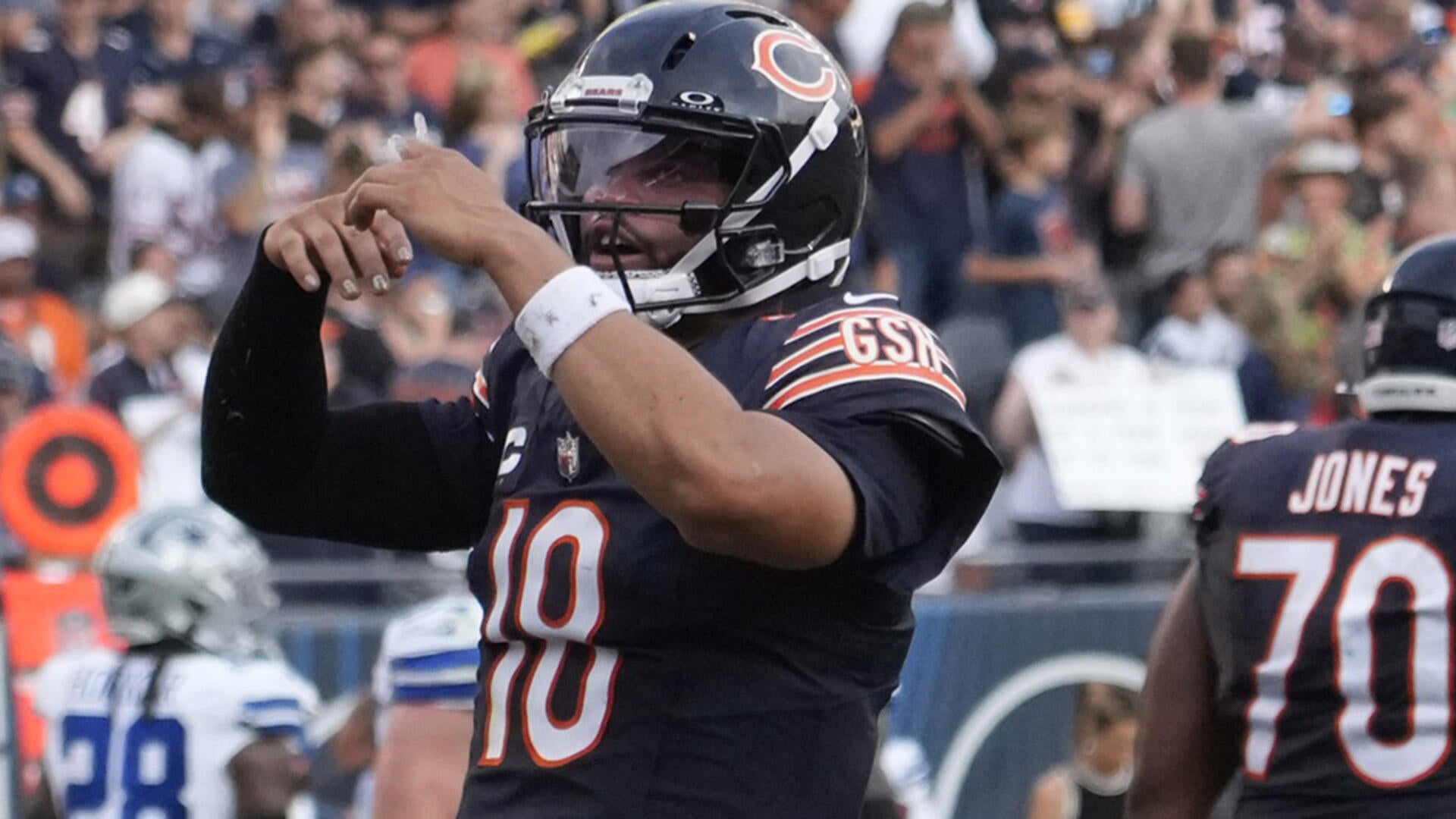 Sep 21, 2025; Chicago, Illinois, USA; Chicago Bears quarterback Caleb Williams (18) gestures after throwing a touchdown against the Dallas Cowboys during the second half at Soldier Field. Mandatory Credit: David Banks-Imagn Images