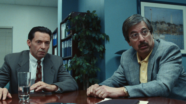 Frank Tassone and Bob Spicer looking alarmed at a table in Bad Education