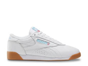White Reebok sneakers with gum soles, featuring the Reebok logo on the side and tongue. Casual, sporty style for everyday wear