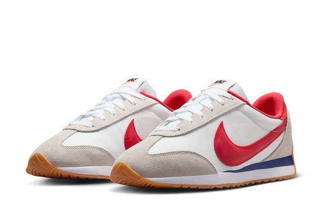 Retro-style sneakers with a large swoosh logo on the side, featuring suede accents and gum soles