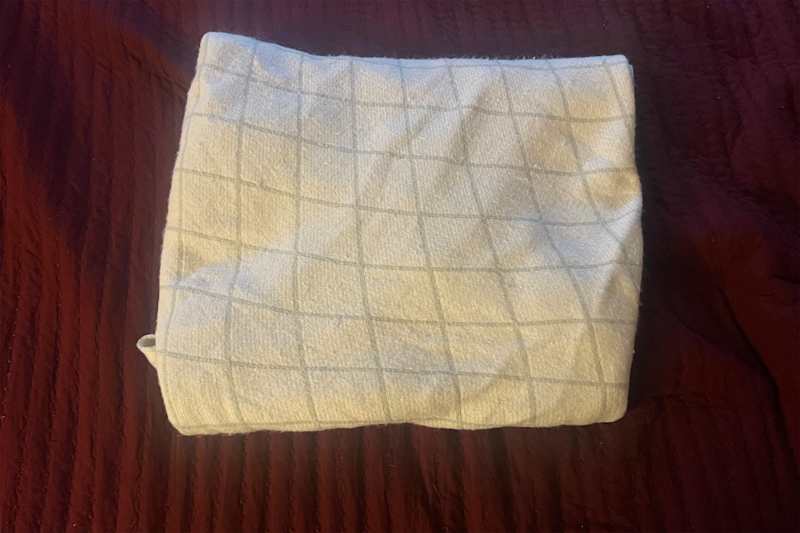 Folded blanket on bed.