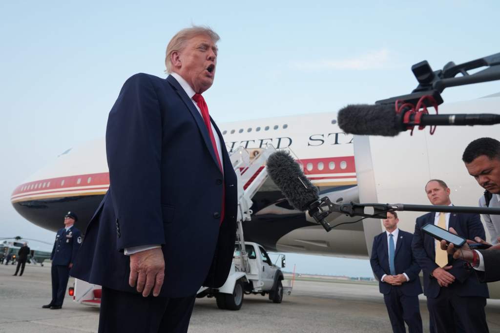 U.S. President Donald Trump speaks to reporters as he exits Air Force One at Joint Base Andrews, Md., after attending the World Cup final soccer match, July 19, 2026.