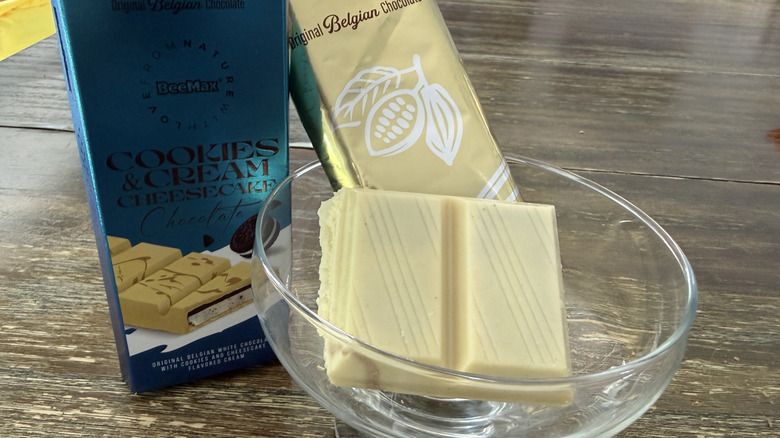 Beemax white chocolate candy bar in glass bowl on wooden table