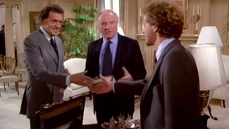 Harry Jr. shaking hands with a client as Harry Sr. watches on in "Crazy like a Fox"