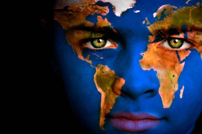 World map overlaid on a human face.