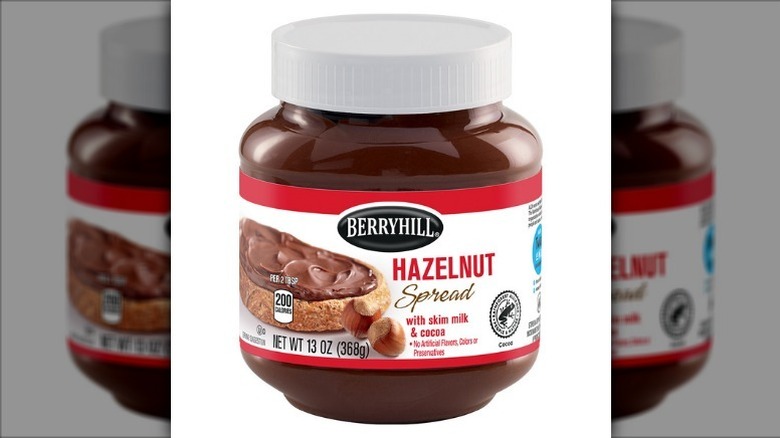 Berryhill hazelnut spread in a plastic jar with a white lid on a white background.