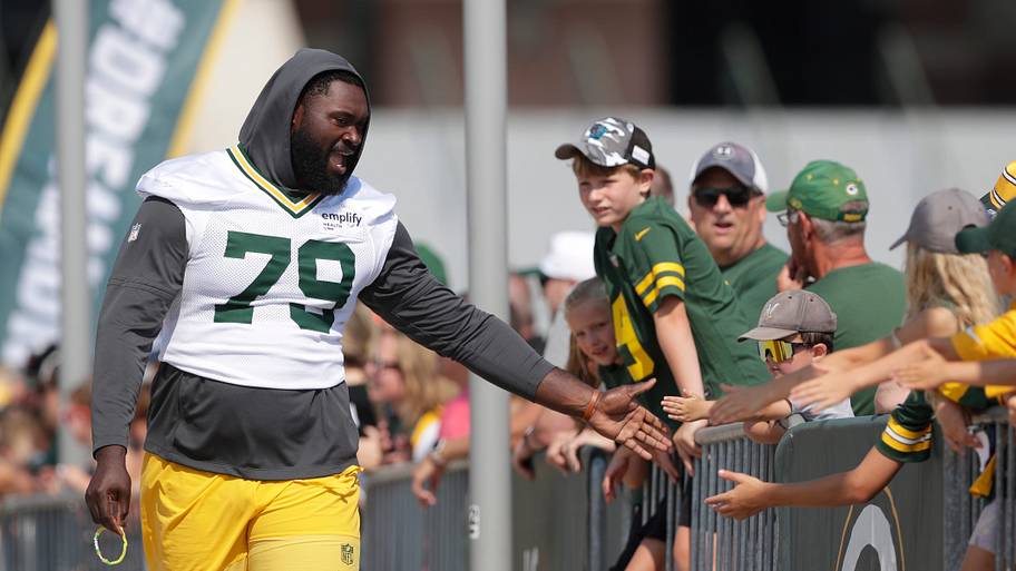 Green Bay Packers tackle Travis Glover (79) greets fans during training camp last year.