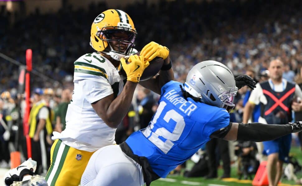 Nov 27, 2025; Detroit, Michigan, USA; Green Bay Packers wide receiver Dontayvion Wicks (13) catches a pass for a touchdown against Detroit Lions safety Thomas Harper (12) during the second quarter at Ford Field. Mandatory Credit: Lon Horwedel-Imagn Images