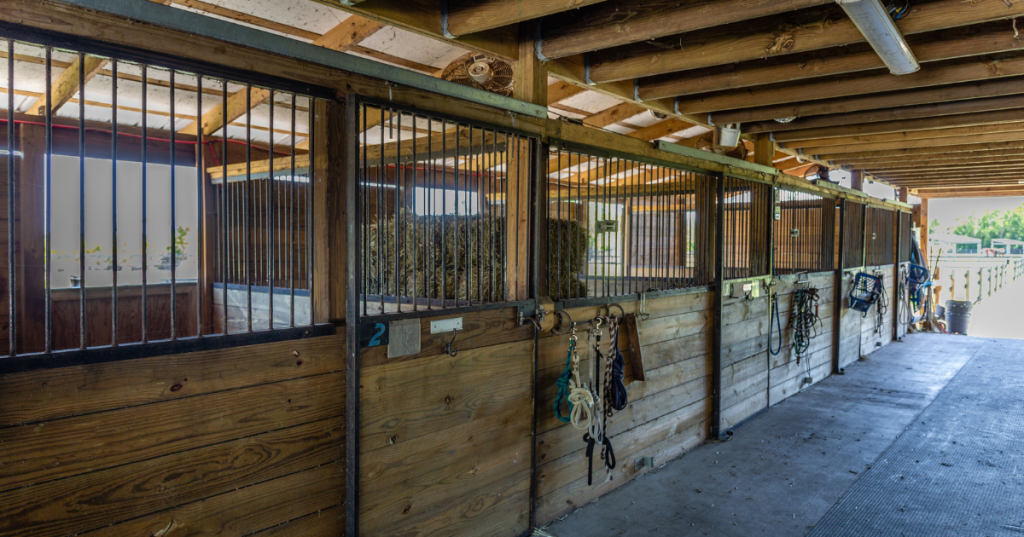 The interior of a wooden stable for horses, each room numbers on thie horse-farm Airbnb.
