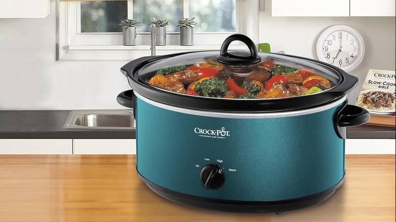 Turquoise blue slow cooker on a kitchen counter