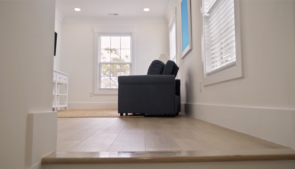 The home's loft area has a lot of natural light filtering in through three windows.
