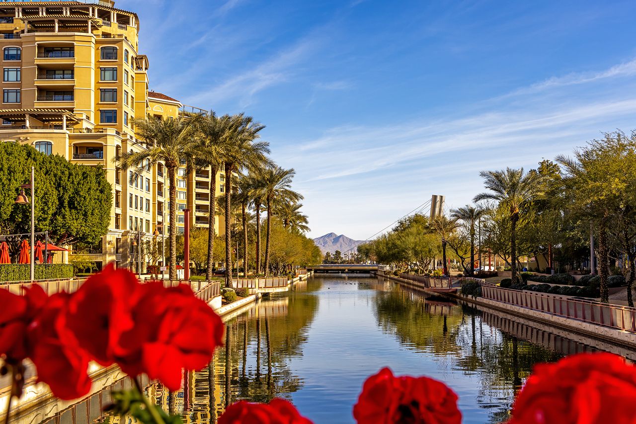Daytime scene of canal running through waterfront housing and shopping district of Old Town Scottsdale