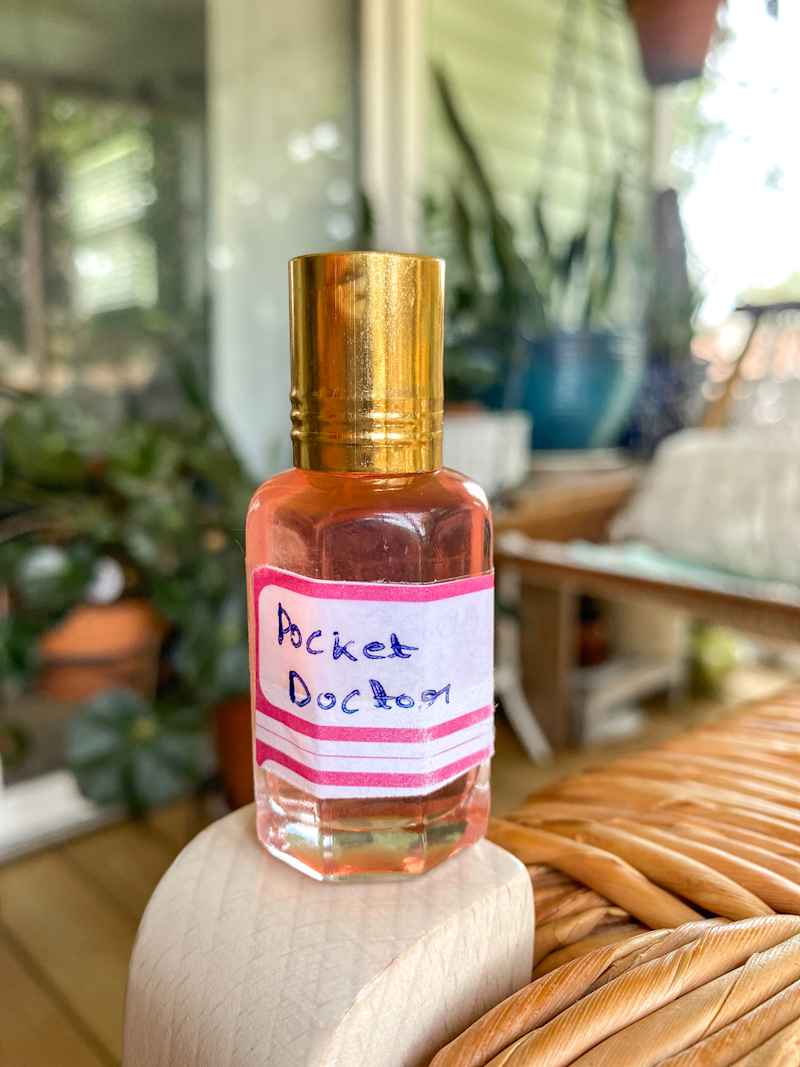 Glass of Pocket Doctor oil.