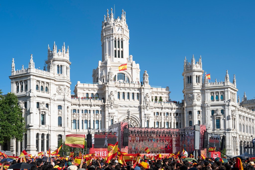 MADRID, SPAIN - 2026/07/20: Spanish football fans gather and wave flags at Plaza de Cibeles during the national team's World Cup victory parade. An estimated two million people flooded the capital's streets to welcome the squad following their 1-0 win against Argentina in the 2026 FIFA World Cup final. (Photo by Miguel Candela/SOPA Images/LightRocket via Getty Images)