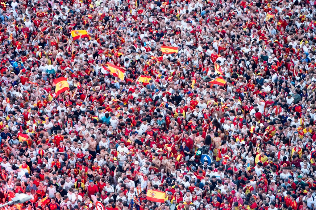 MADRID, SPAIN - 2026/07/20: A high-angle view captures a dense crowd of Spanish football fans packed together and waving flags during the national team's World Cup victory parade. An estimated two million people flooded the capital's streets to welcome the squad following their 1-0 win against Argentina in the 2026 FIFA World Cup final. (Photo by Miguel Candela/SOPA Images/LightRocket via Getty Images)