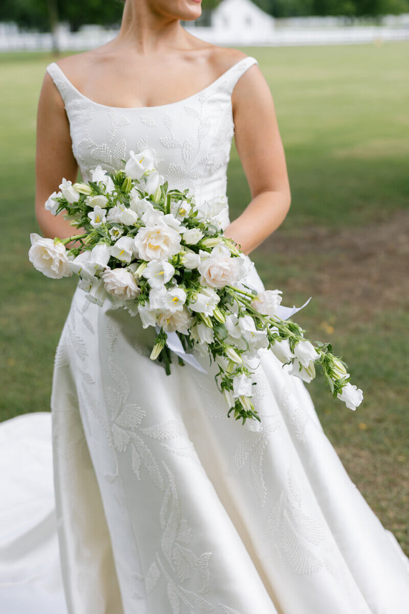 Claire’s bouquet featured lilies of the valley, which were also woven into the wedding cake’s design. Image: Rachel Fugate Photography