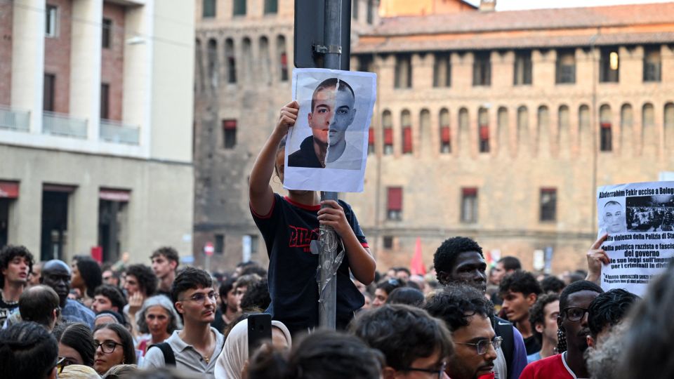 A protester pictured holding a portrait of Abderrahim Fakir above the crowd. - Michele Lapini/Reuters