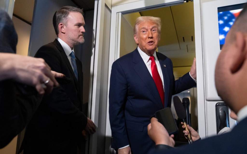 FILE - U.S. President Donald Trump speaks with reporters aboard Air Force One as U.S. Trade Representative Jamieson Greer, left, listens, shortly after taking off from Busan, South Korea, en route to Joint Base Andrews, Md., Oct. 30, 2025.