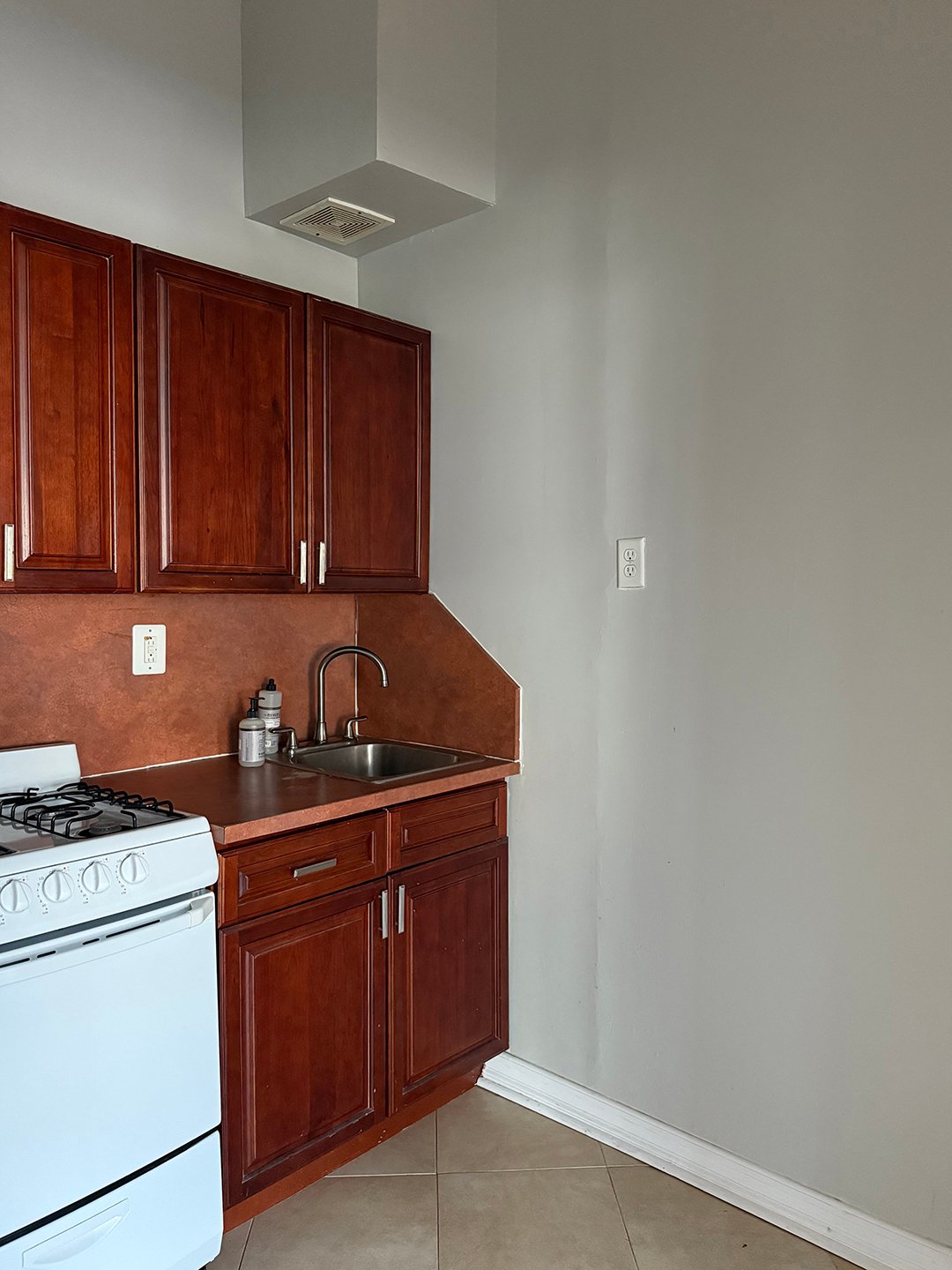white kitchen with dark red cabinets