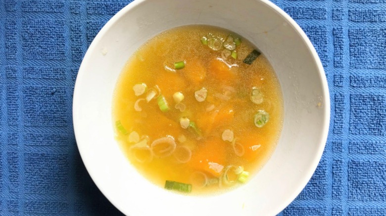 Bowl of squash soup on blue towel