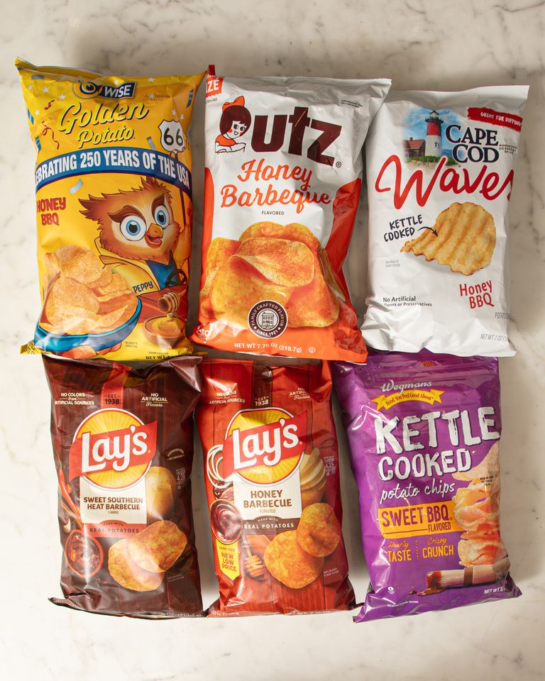 Six bags of chips arranged on a surface featuring various brands and flavors