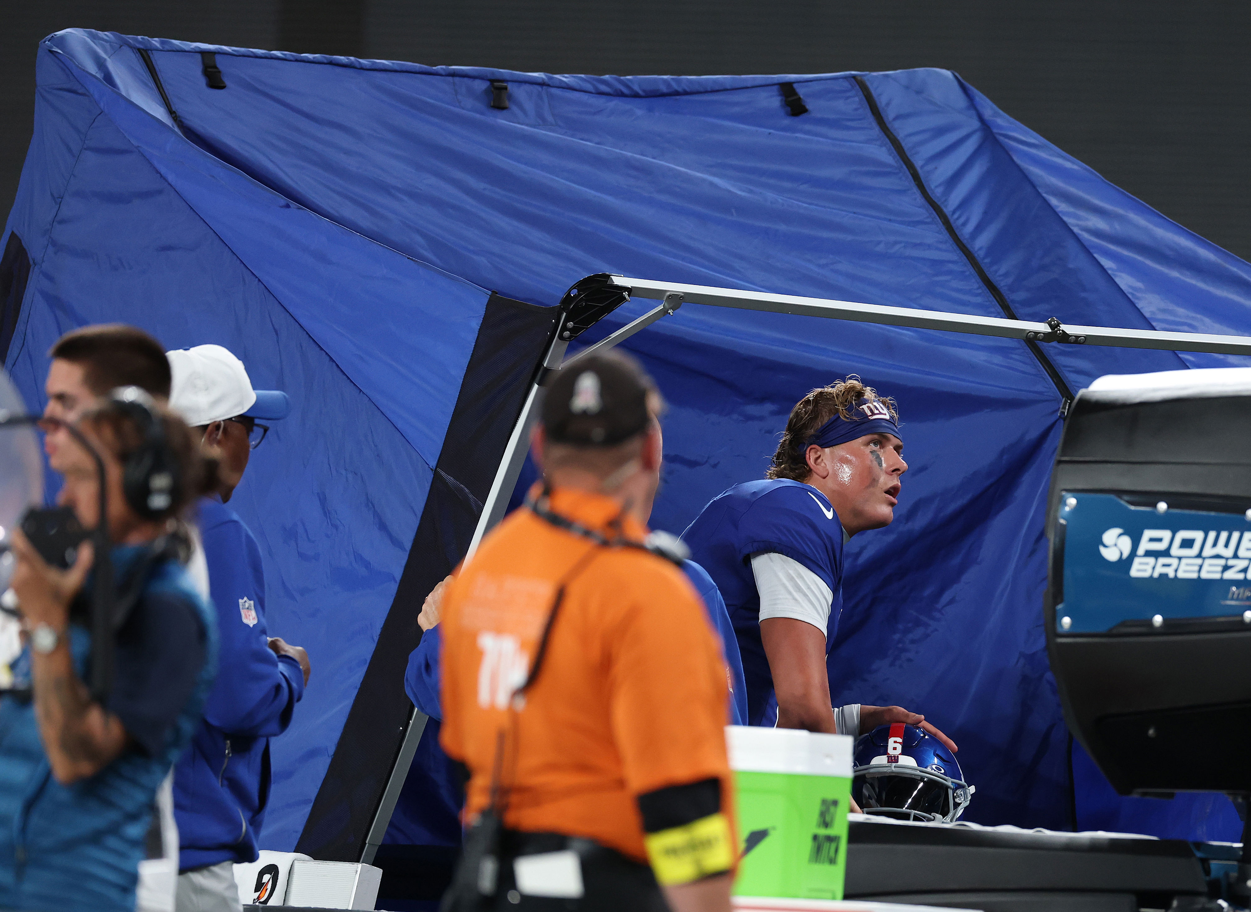 EAST RUTHERFORD, NEW JERSEY - AUGUST 21: Jaxson Dart #6 of the New York Giants sits in the medical tent after a hard tackle by Jack Gibbens #51 of the New England Patriots during their NFL Preseason game at MetLife Stadium on August 21, 2025 in East Rutherford, New Jersey. (Photo by Al Bello/Getty Images)