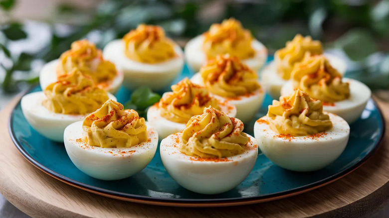 A turquoise plate holds deviled eggs
