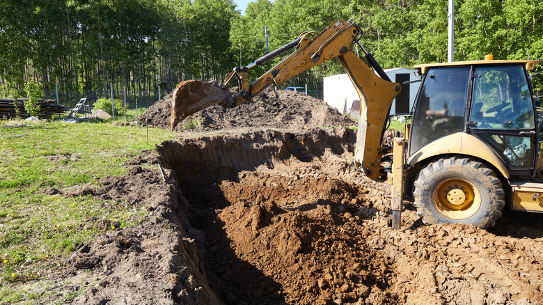 A backhoe loader digging up dirt.