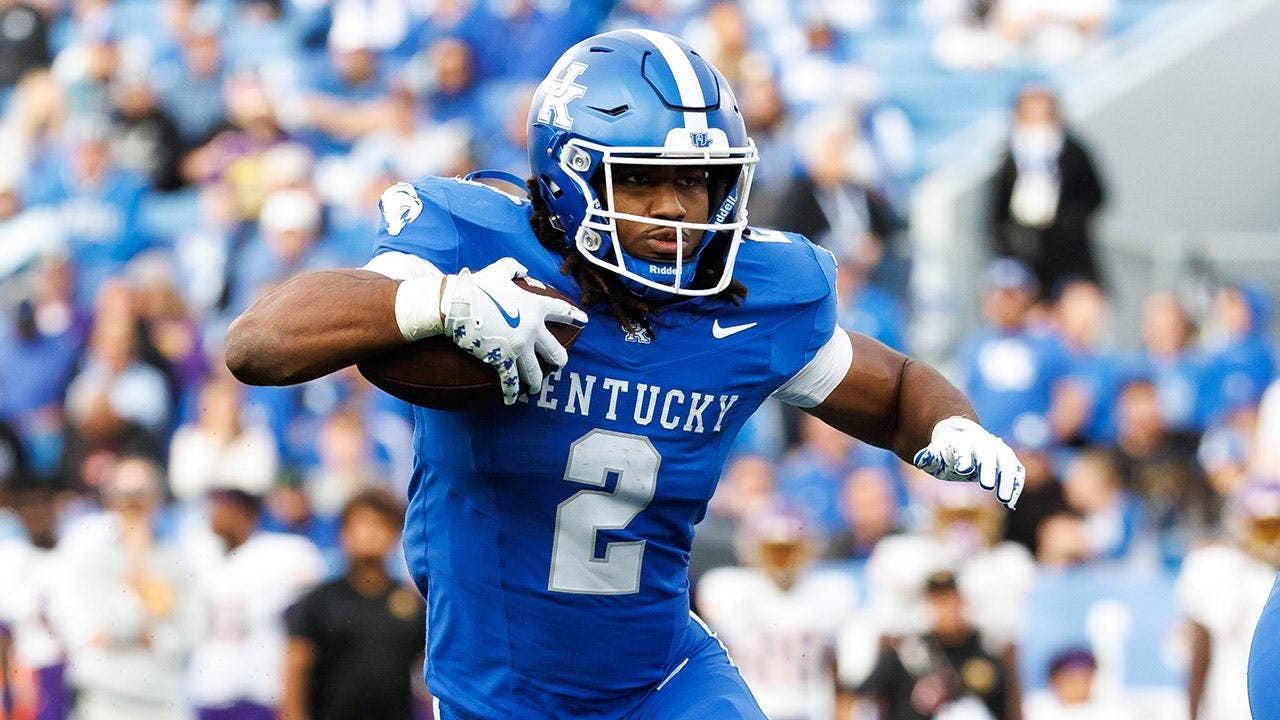 Dante Dowdell runs with the ball during a football game at Kroger Field.