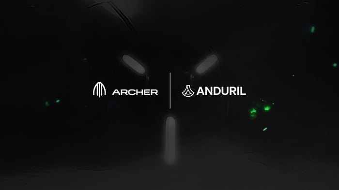 Archer and Anduril logos on a dark background with glowing green and white lights