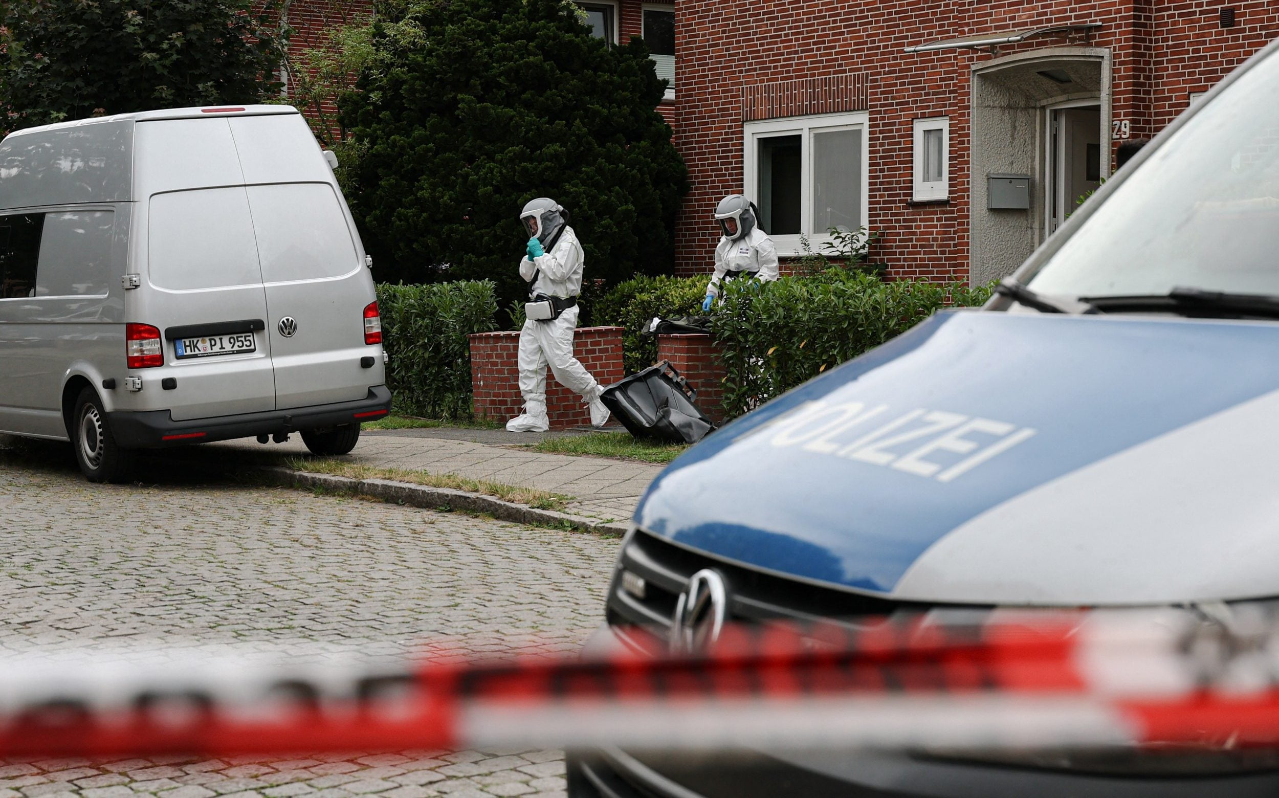 Forensic Police officers work at the scene where six people were killed in a shooting the day before in Stade