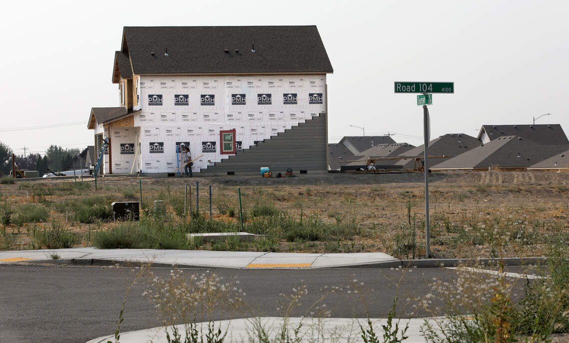 New homes under construction and empty lots are available on Sunset Trail near the intersection with Road 104 in a new housing development in Pasco.