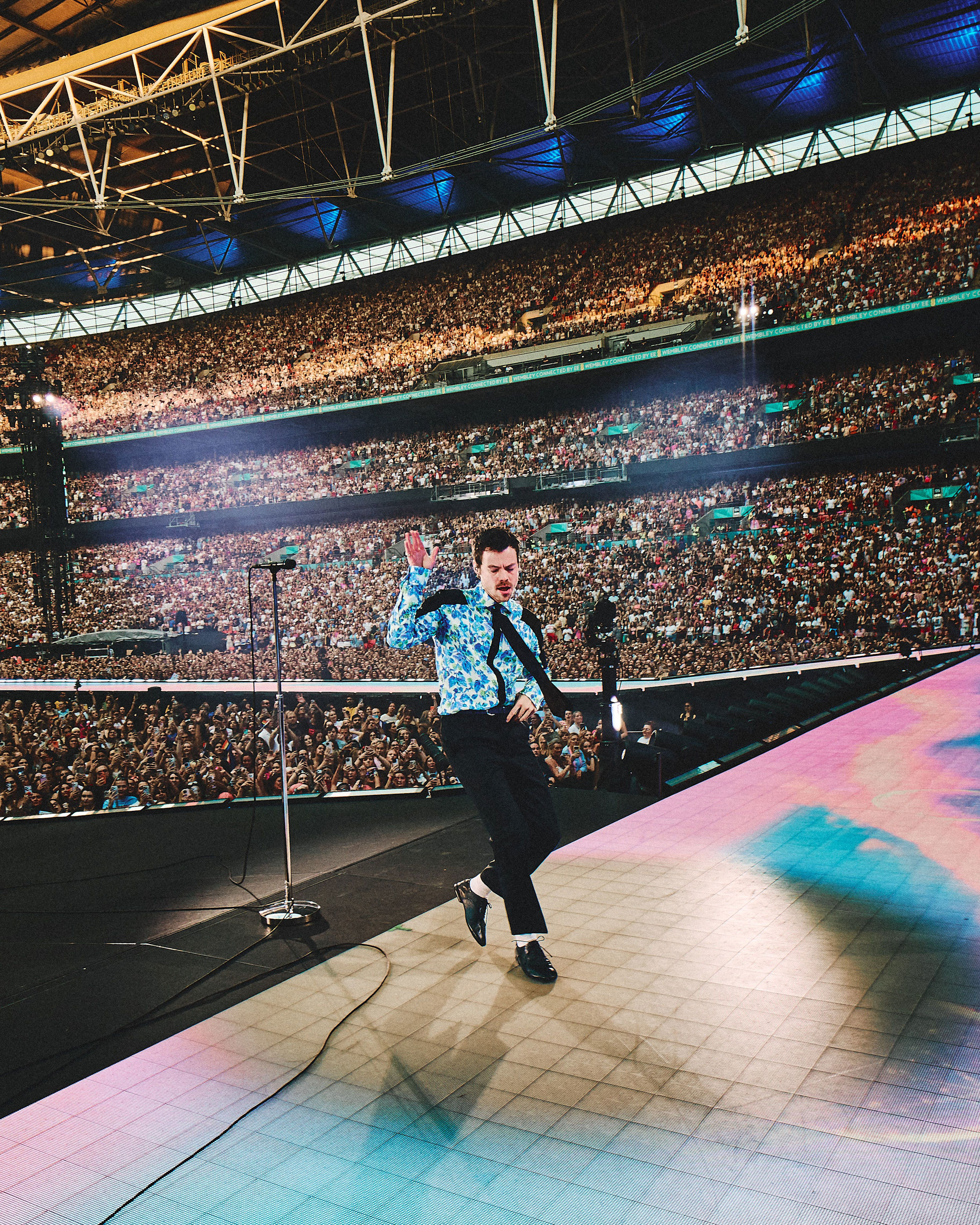 Harry Styles performing at Wembley Stadium during his 