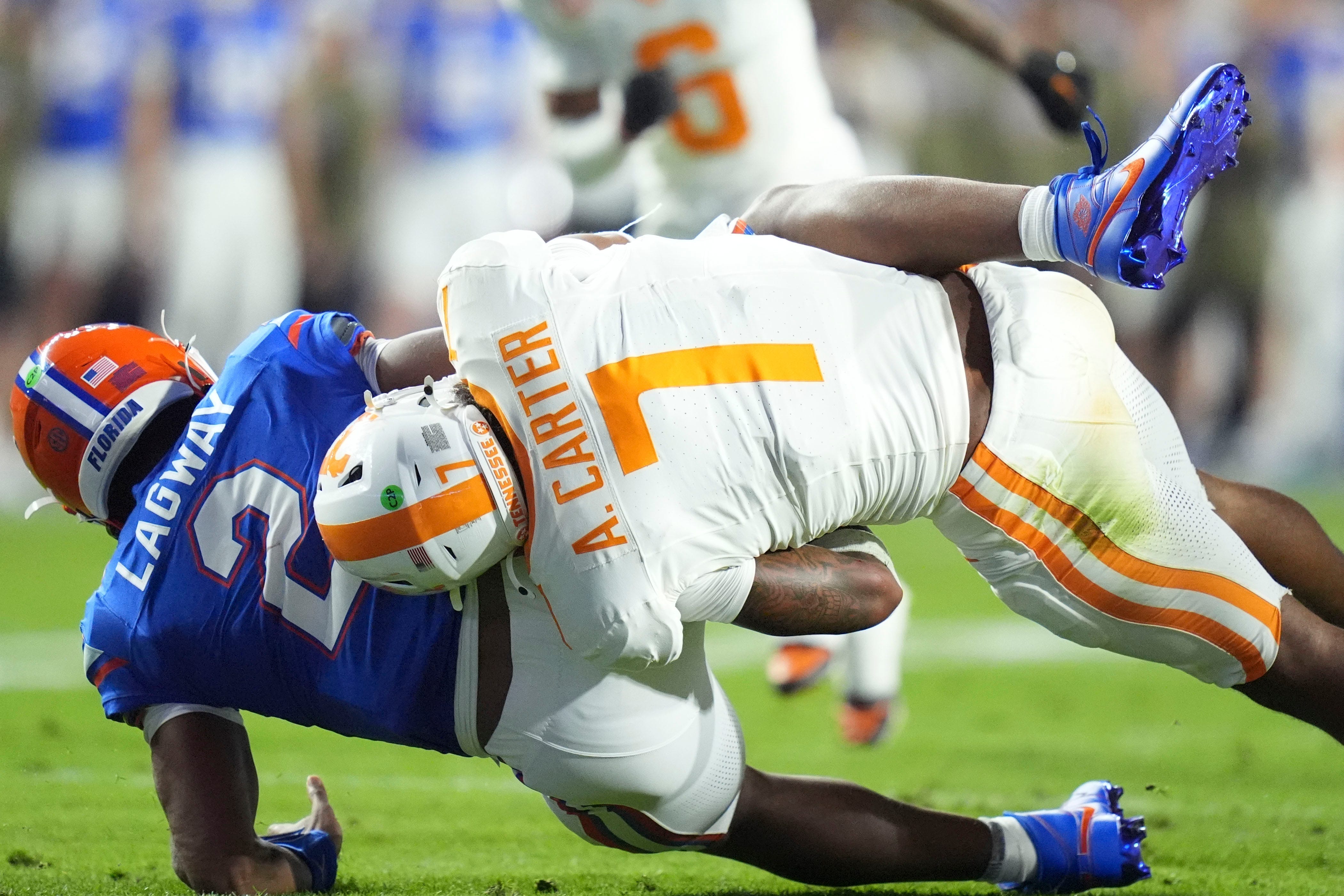 Tennessee linebacker Arion Carter (7) takes down Florida quarterback DJ Lagway (2) in an NCAA college football game on November 22, 2025, in Gainesville, Florida.
