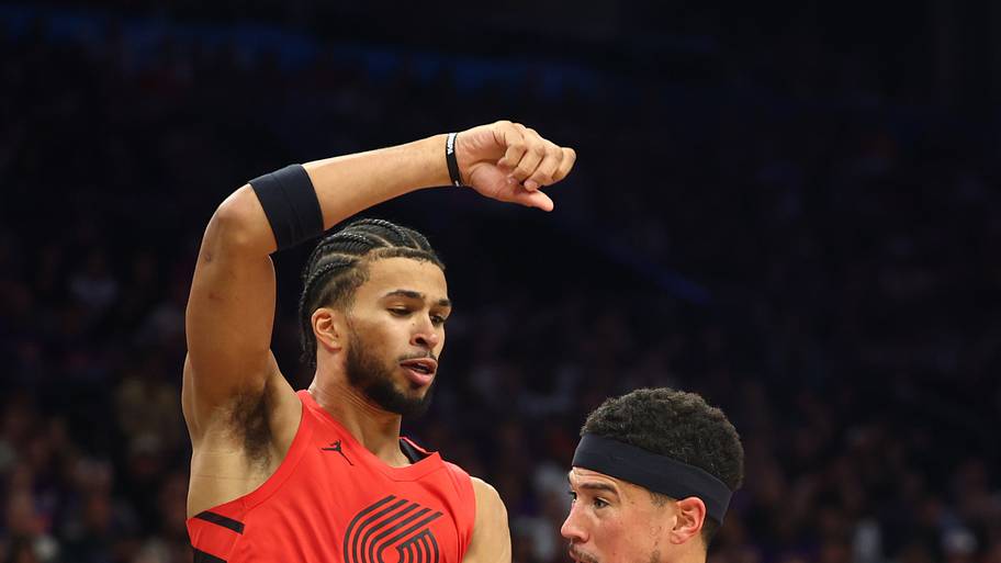 Portland Trail Blazers forward Toumani Camara (33) defends against Phoenix Suns guard Devin Booker (1)