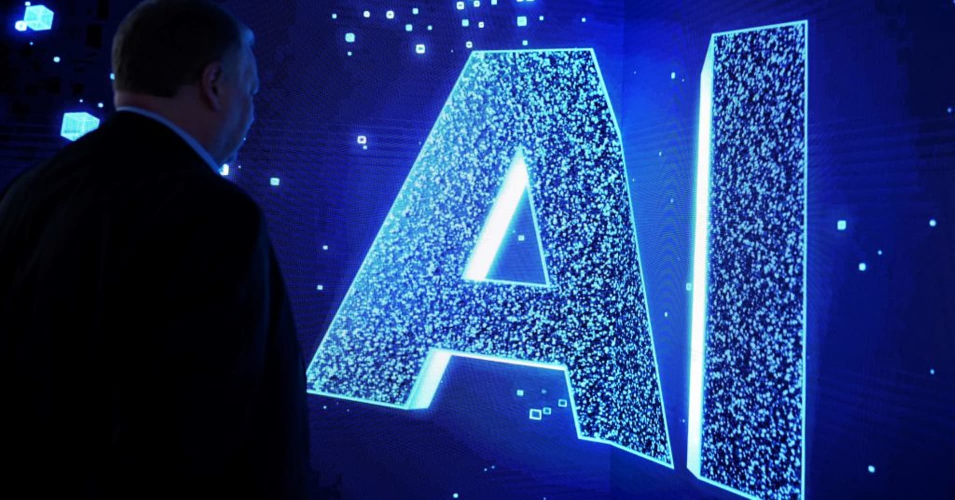 A visitor watches an AI sign on an animated screen at the Mobile World Congress, the telecom industry's biggest annual gathering, in Barcelona, Spain.