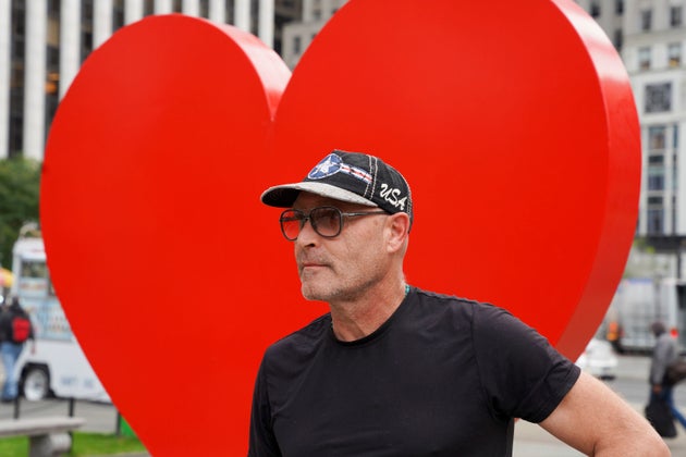 Italian sculptor Sergio Furnari poses for pictures in front of “The Hero Monument” heart sculpture that he made, a symbol of hope and love dedicated to health care workers around the world, Monday, Oct. 25, 2021, in Manhattan’s Grand Army Plaza in New York.